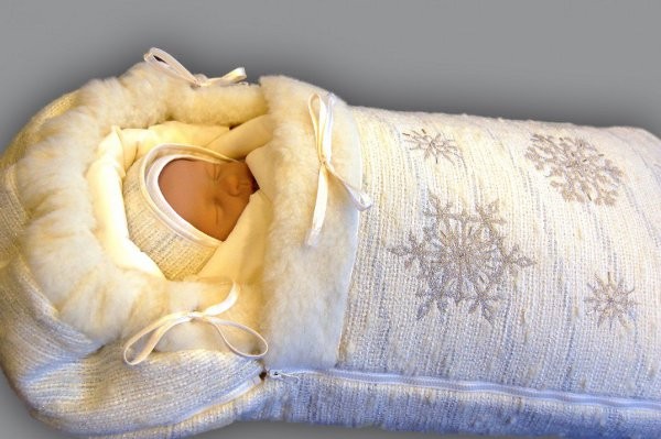 Новорождённый малыш (кукла) в тёплом зимнем конверте